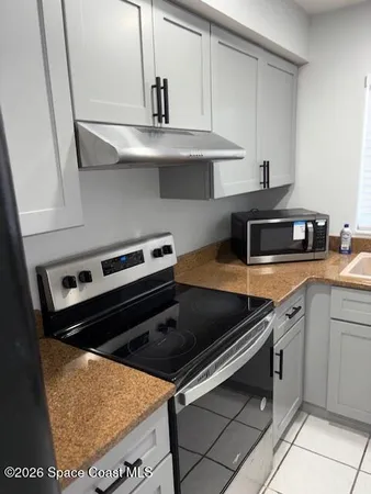 a stove top oven sitting inside of a kitchen