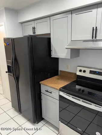 a kitchen with stainless steel appliances a refrigerator a stove and cabinets