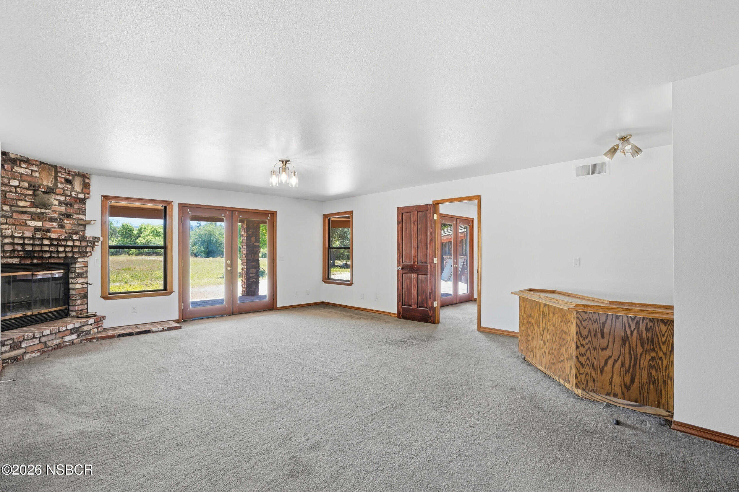140 East Rice Ranch Road Santa Maria, CA 93455 - Photo 10 of 44 a view of an empty room with a fireplace and a window