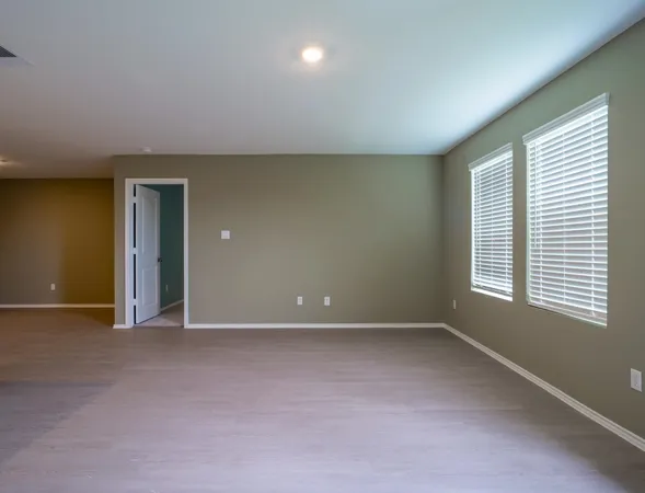 an empty room with a empty space and windows