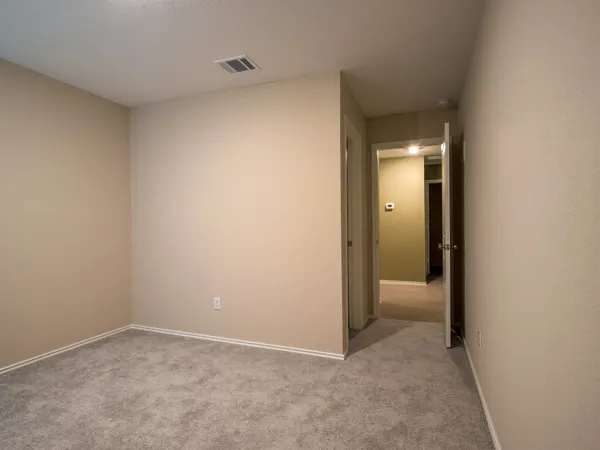 a view of an empty room and closet area
