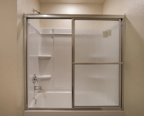 a bathroom with a glass shower door