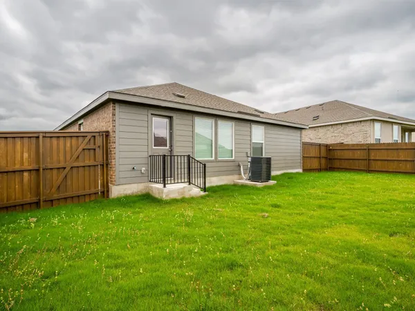 a view of a backyard with a garden and entertaining space