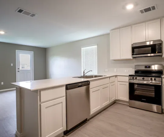 a kitchen with stainless steel appliances granite countertop a sink and a stove top oven