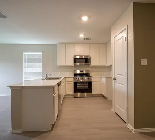 a kitchen with kitchen island a sink stainless steel appliances and cabinets