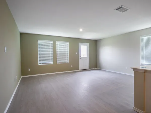 an empty room with windows and closet