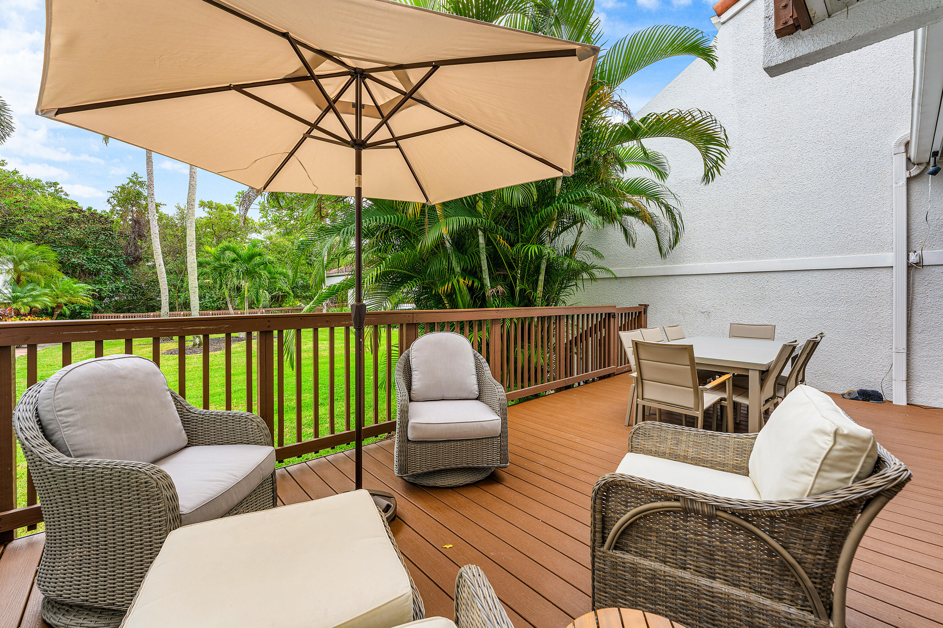 5578 North Ocean Boulevard, Unit 28F Ocean Ridge, FL 33435 - Photo 16 of 47 a view of a patio with couches chairs under an umbrella