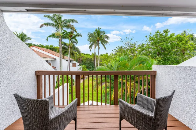 a view of a balcony with furniture