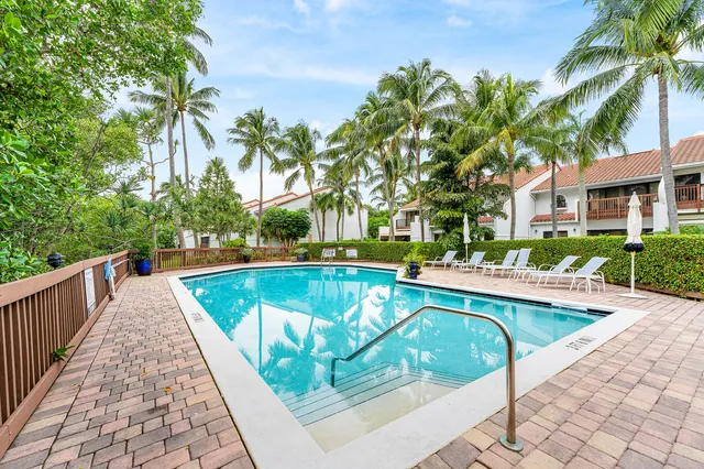 a view of swimming pool with outdoor seating and plants