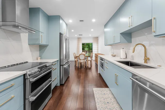 a kitchen with granite countertop a stove and a sink
