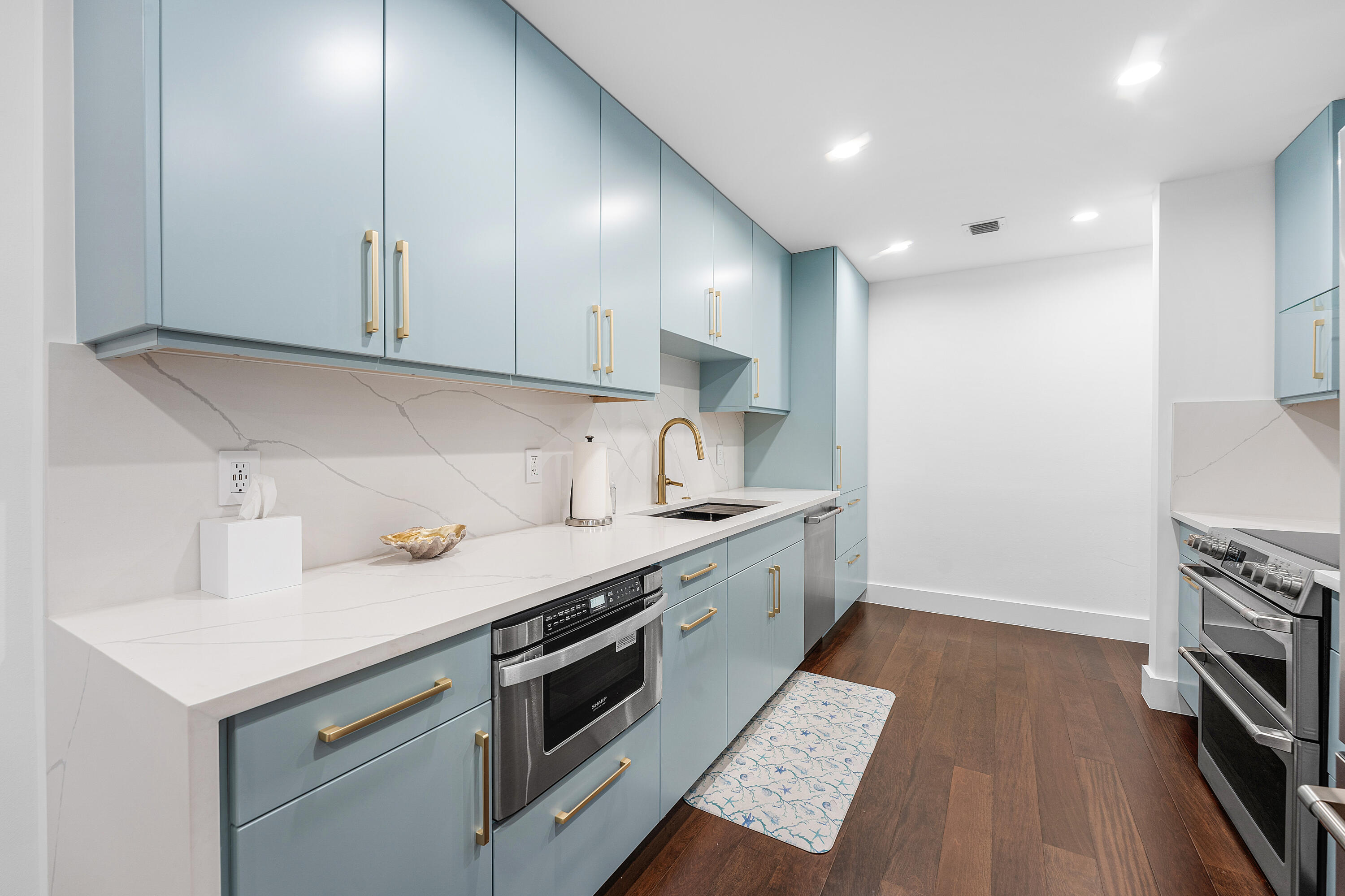 5578 North Ocean Boulevard, Unit 28F Ocean Ridge, FL 33435 - Photo 6 of 47 a kitchen with a sink a stove and cabinets