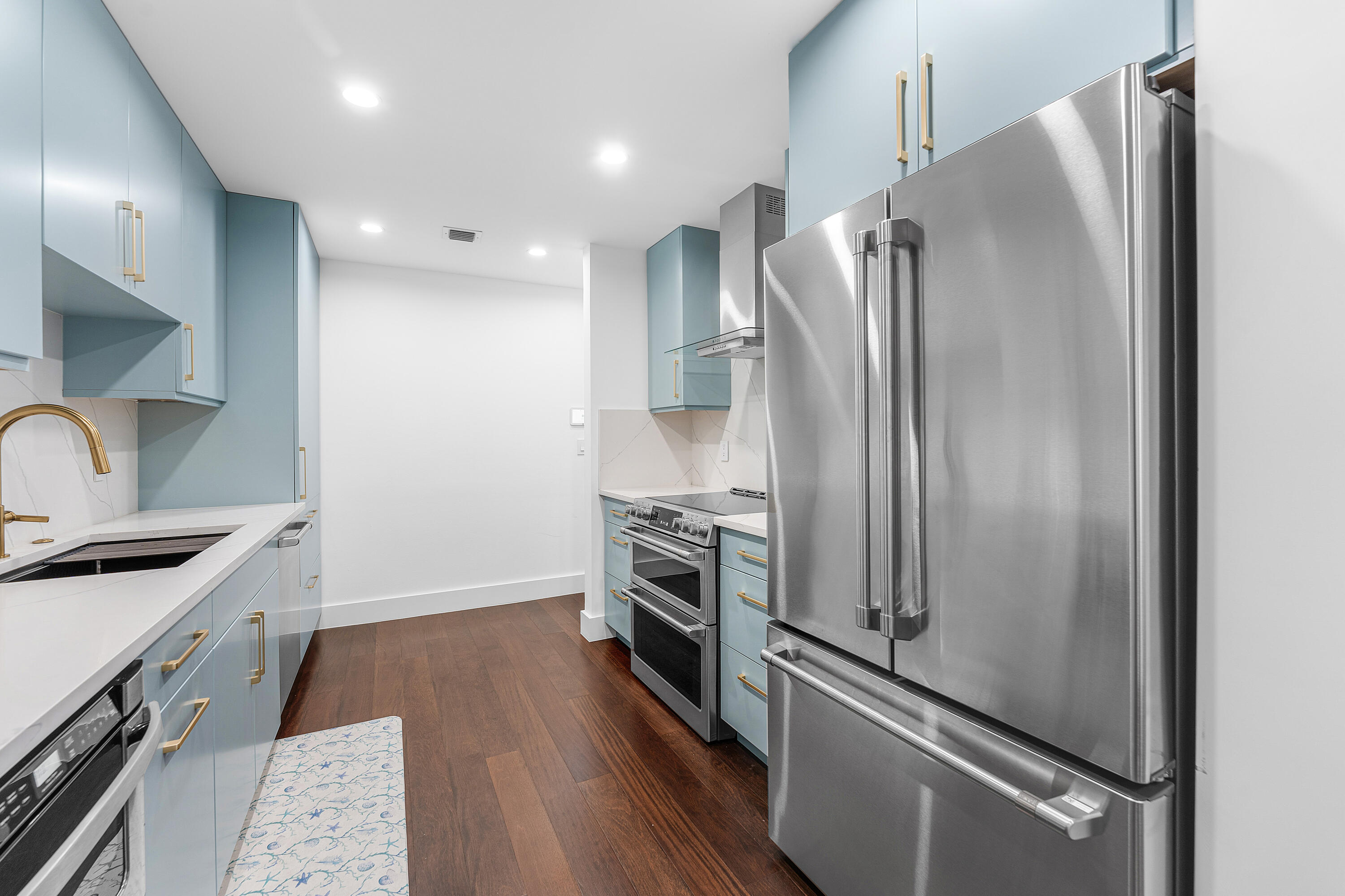 5578 North Ocean Boulevard, Unit 28F Ocean Ridge, FL 33435 - Photo 7 of 47 a kitchen with a refrigerator and a sink