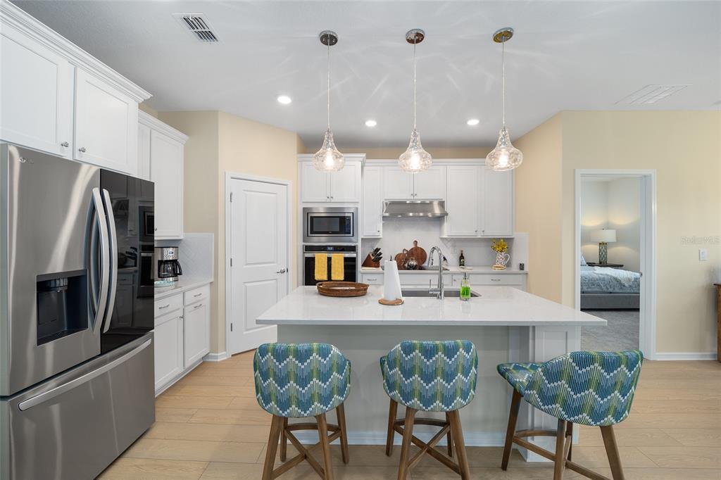 8491 Southwest 52nd Ln Road Ocala, FL 34481 - Photo 14 of 45 a kitchen with refrigerator and chairs