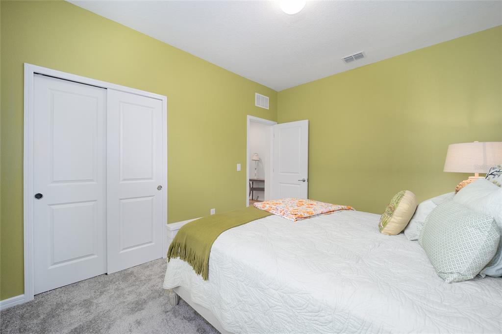 8491 Southwest 52nd Ln Road Ocala, FL 34481 - Photo 29 of 45 a bedroom with a bed and cupboard