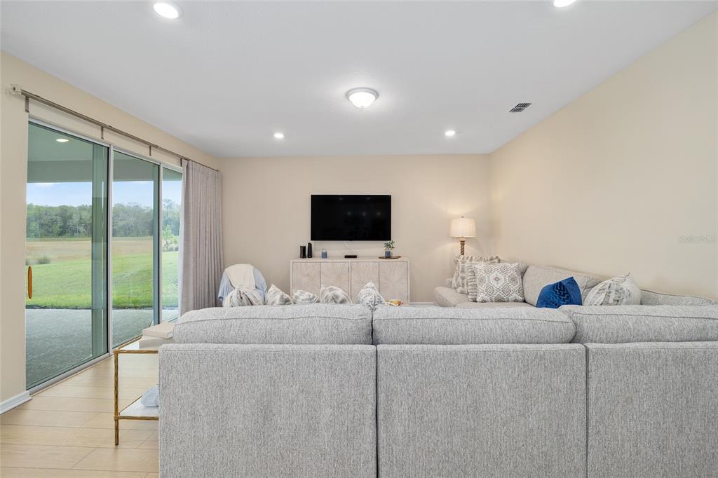 8491 Southwest 52nd Ln Road Ocala, FL 34481 - Photo 8 of 45 a living room with furniture and a flat screen tv