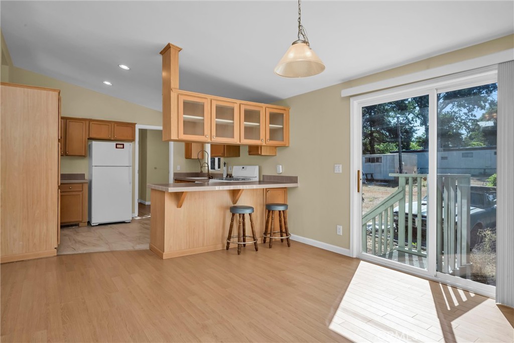 16410 Tish-A-Tang Road Lower Lake, CA 95457 - Photo 10 of 48 a kitchen with refrigerator and table