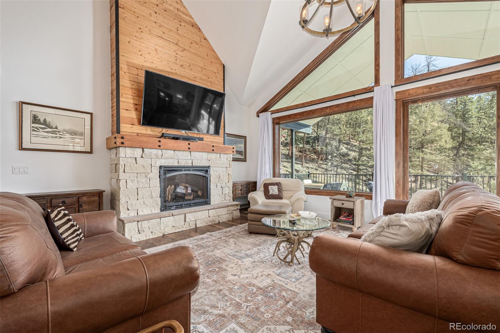 663 Brookside Drive Bailey, CO 80421 - Photo 8 of 47 a living room with furniture a flat screen tv and a fireplace