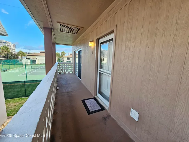 a view of a backyard with wooden floor and outdoor seating