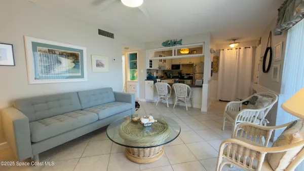 a living room with furniture a dining table and a bookshelf
