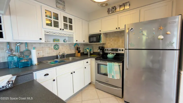 a white refrigerator freezer sitting inside of a kitchen