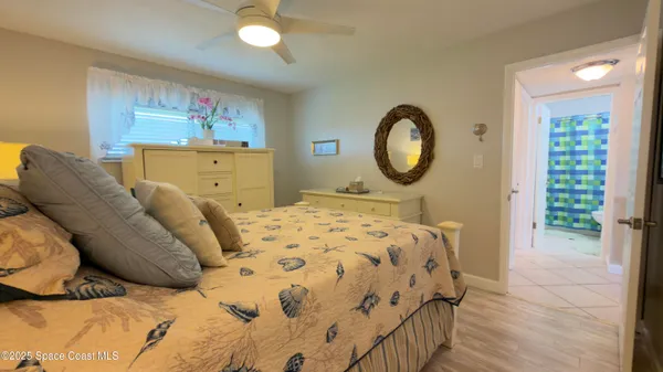 a bedroom with a bed and a mirror