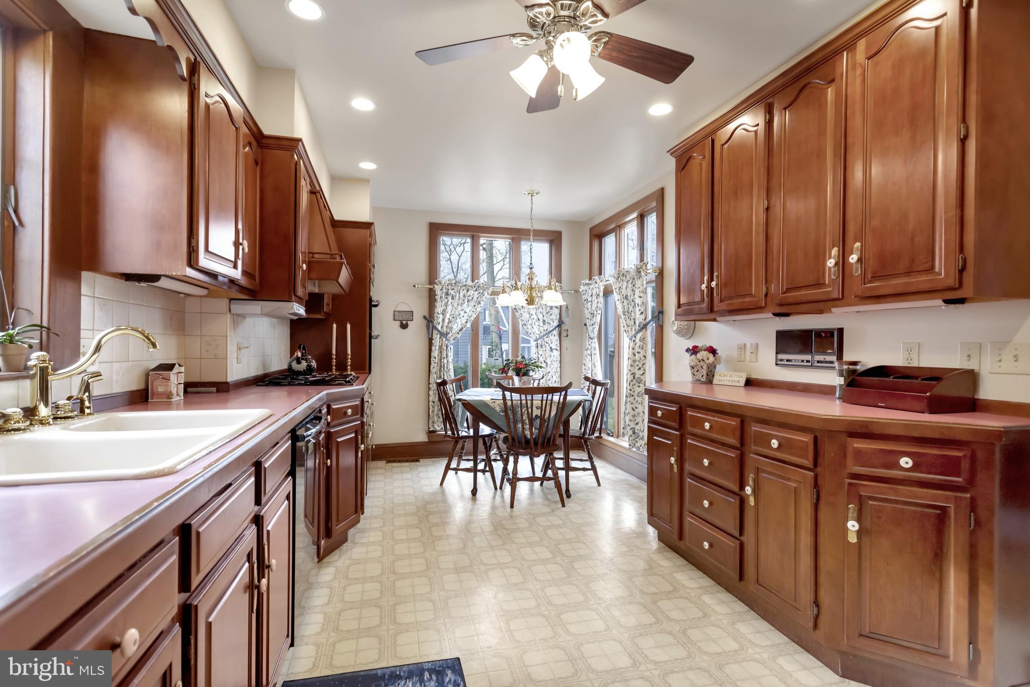 316 Chestnut Street Haddonfield, NJ 08033 - Photo 10 of 30 a kitchen with stainless steel appliances granite countertop a refrigerator a sink dishwasher a stove and a dining table with wooden cabinet