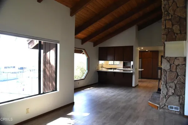 a view of kitchen with furniture and refrigerator