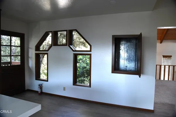 an empty room with windows and closet