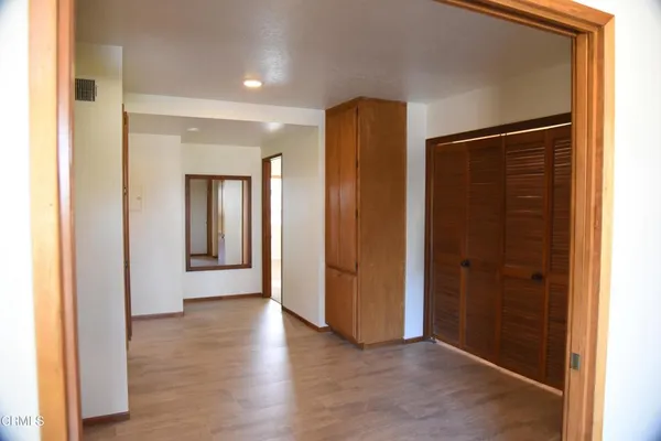 a view of a hallway with wooden floor
