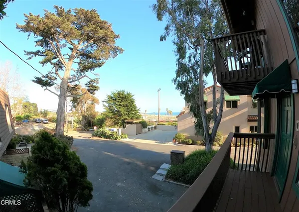 a view of a pathway of a house with flower plants