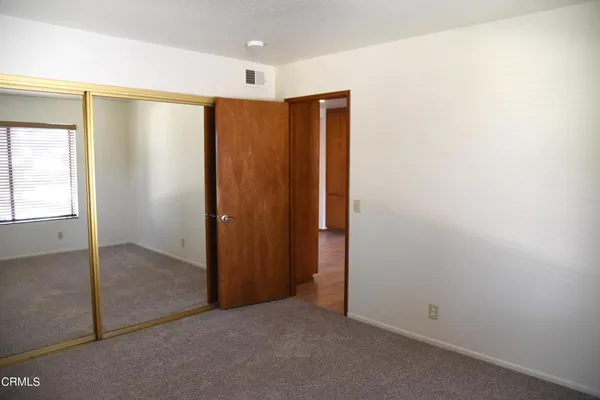 an empty room with closet area