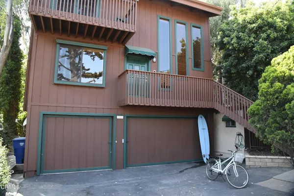 a front view of a house with parking area