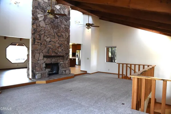 a view of a livingroom with fireplace and window