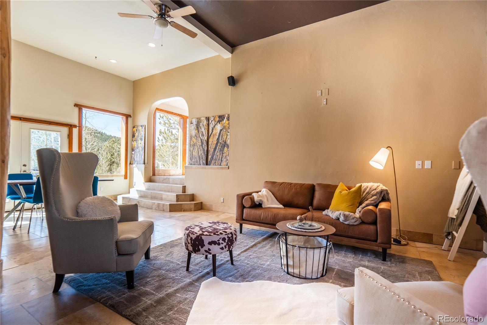 252 Jones Road Bailey, CO 80421 - Photo 21 of 36 a living room with furniture and a chandelier