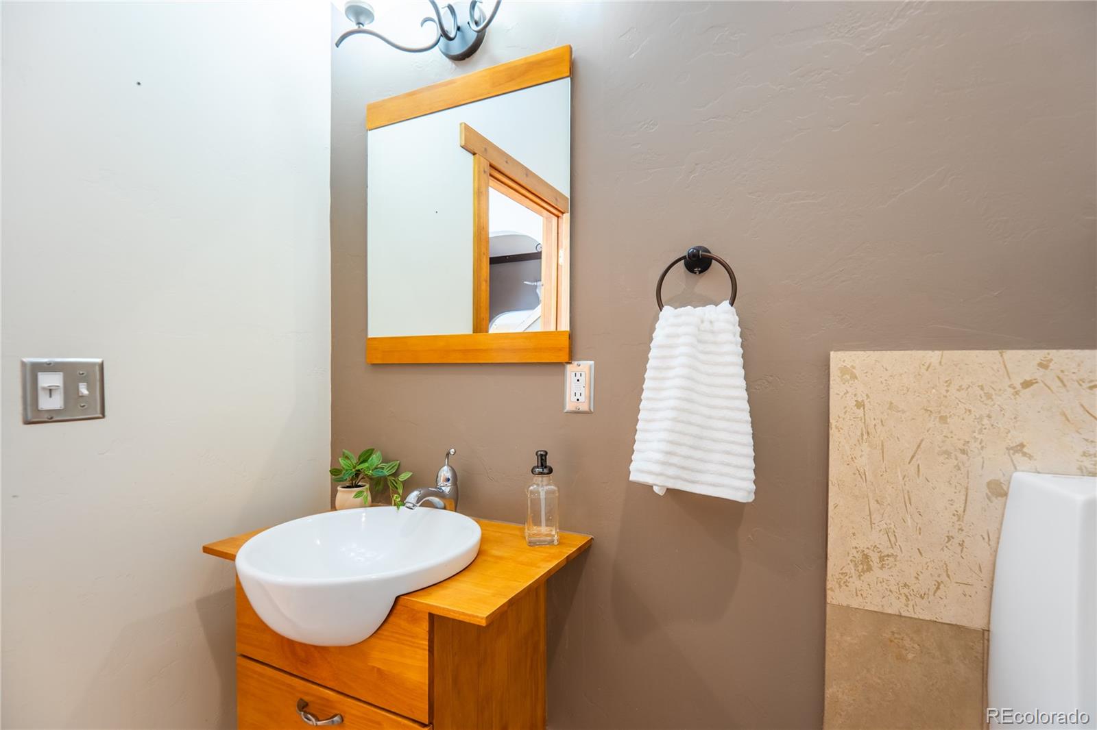 252 Jones Road Bailey, CO 80421 - Photo 26 of 36 a bathroom with a sink a mirror and a toilet
