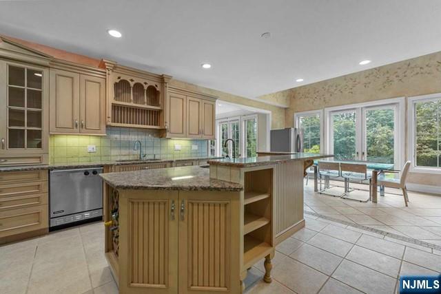 1 Euclid Road Fort Lee, NJ 07024 - Photo 12 of 50 a kitchen with granite countertop a stove a sink and a microwave