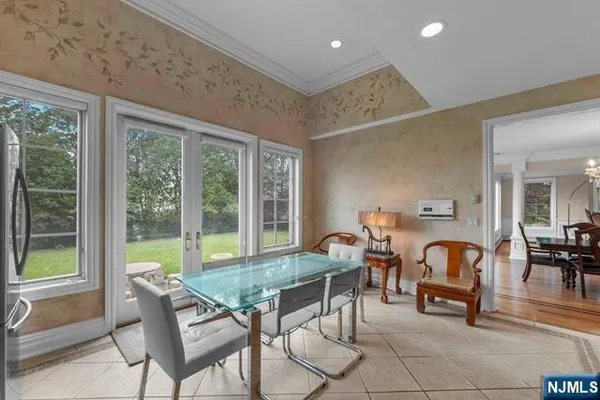 a dining room with furniture water view and large windows