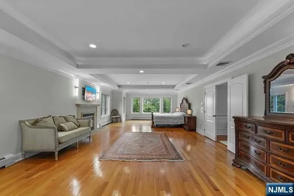 a spacious bedroom with a bed and a fireplace