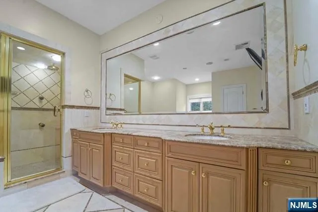 a bedroom with a large bed and large windows