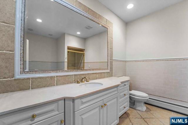 1 Euclid Road Fort Lee, NJ 07024 - Photo 29 of 50 a bathroom with a sink a toilet a mirror and vanity