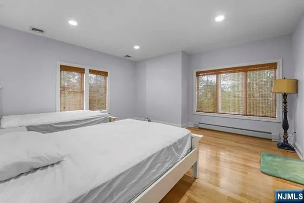 a spacious bedroom with a bed and a cabinets