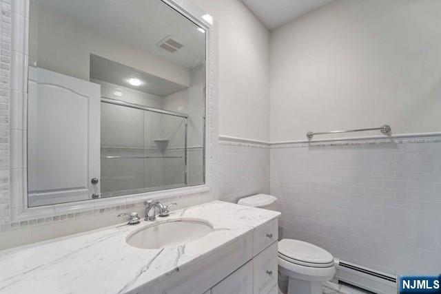 1 Euclid Road Fort Lee, NJ 07024 - Photo 32 of 50 a bathroom with a granite countertop sink toilet a mirror and shower