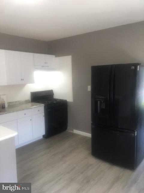 1402 Collings Road, Unit DOWNSTAIRS Camden, NJ 08104 - Photo 4 of 12 a kitchen with granite countertop white cabinets and refrigerator