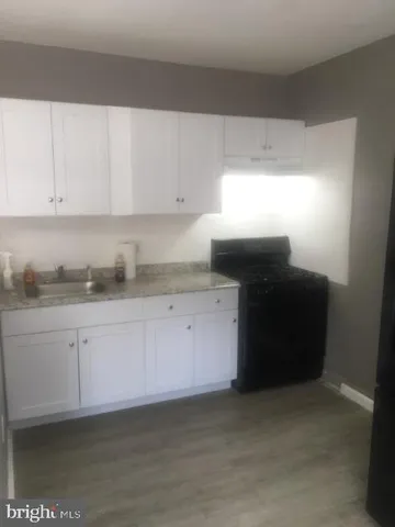 a kitchen with granite countertop white cabinets and granite counter tops
