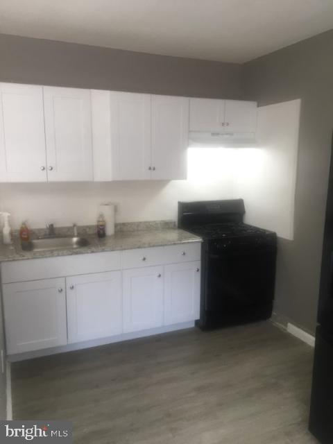 1402 Collings Road, Unit DOWNSTAIRS Camden, NJ 08104 - Photo 5 of 12 a kitchen with granite countertop white cabinets and granite counter tops