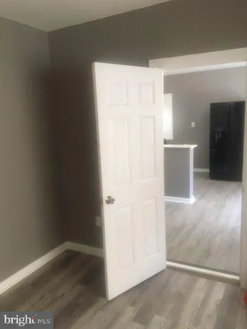 an empty room with wooden floor and closet