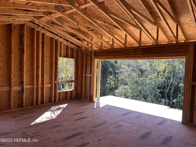 a view of livingroom with floor to ceiling windows and wooden floor