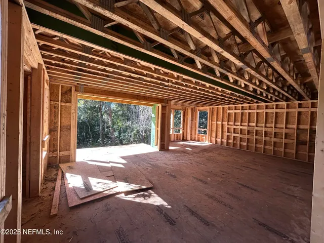 a big room with wooden floor and windows