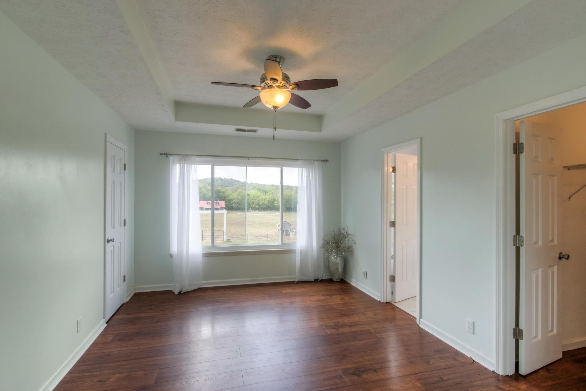 1046 Rocky Valley Road Lebanon, TN 37090 - Photo 9 of 30 The master bedroom has a ceiling fan, tray ceiling and TWO walk in closets
