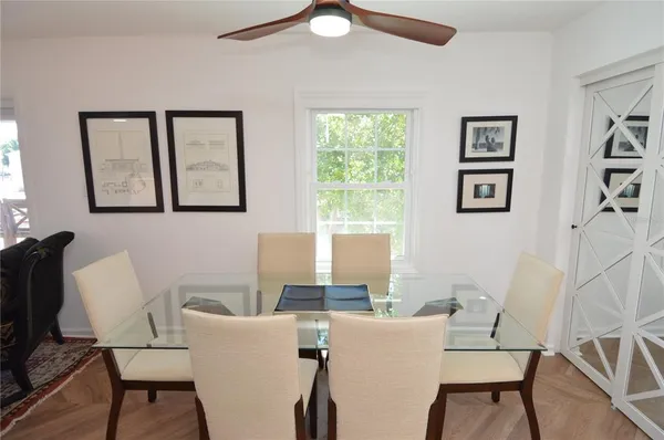 a large bed sitting in a bedroom next to a window with pc on the table